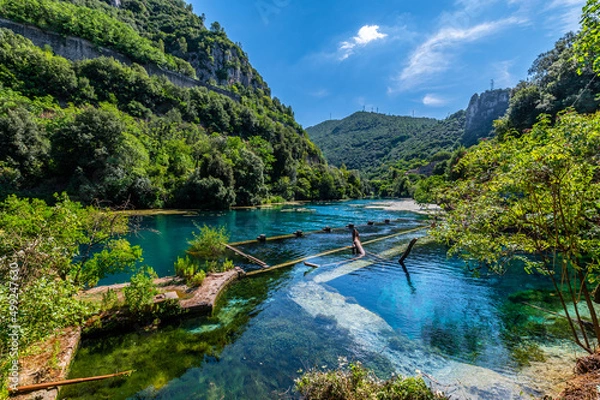 Fototapeta The Roman port of ancient Narnia in Stifone, in the canyons of the Nera river. The blue sky and the clear, cold and turquoise water, on a sunny day in the summer.