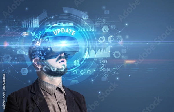 Fototapeta Businessman looking through VR glasses