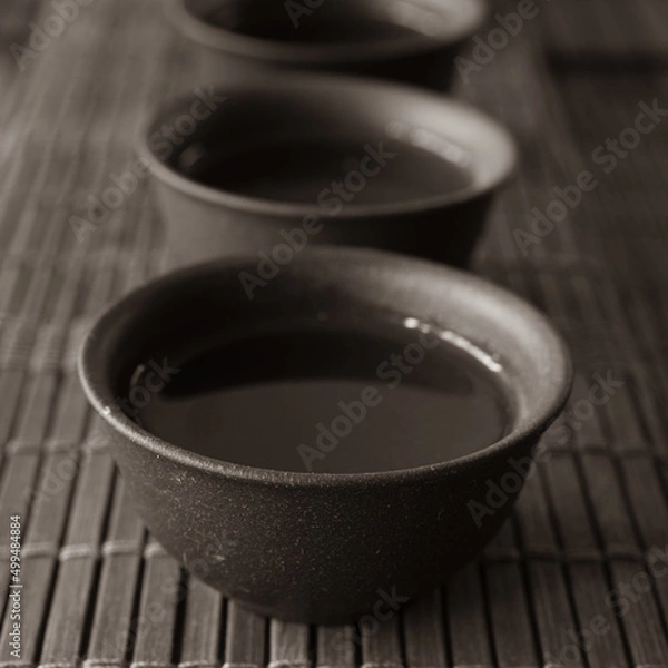 Obraz tea set on a table with a bamboo mat