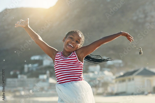 Fototapeta Summers finally here. Portrait of an adorable little girl having fun at the beach.