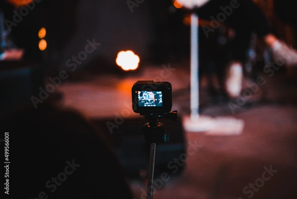 Fototapeta a man shoots a video on an action camera at a concert