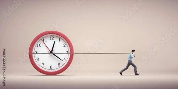 Fototapeta Man drag a clock with a rope.