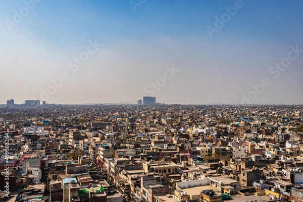 Fototapeta crowded city construction with flat hazy sky at morning from unique angle