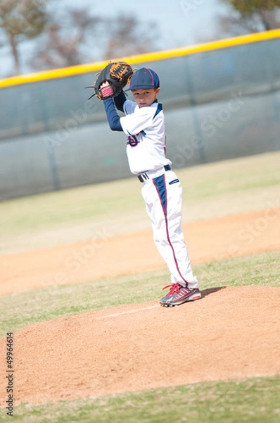 Fototapeta Little league pitcher starting his wind up.