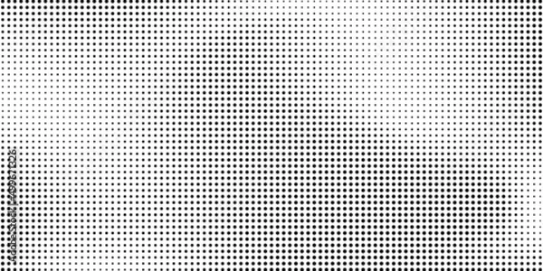 Fototapeta Halftone dotted background. Black dots in modern style on a white background.