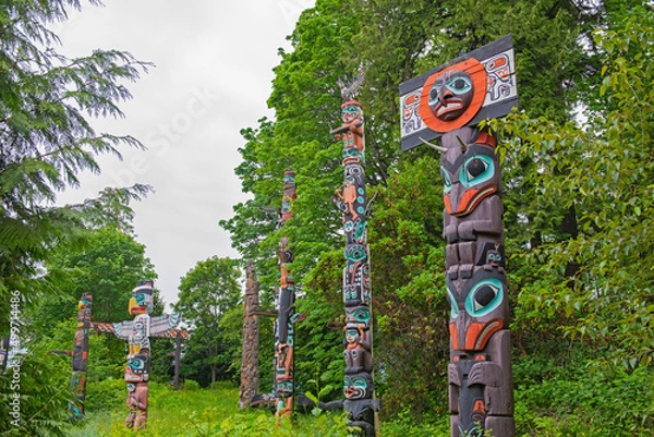 Obraz VANCOUVER - May 28, 2019: View of carved totem poles in Stanley Park, a popular lardmark and destination in British Columbia, Canada.