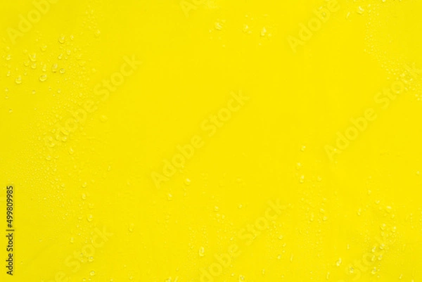 Fototapeta Yellow smooth surface with drops of water as textural background