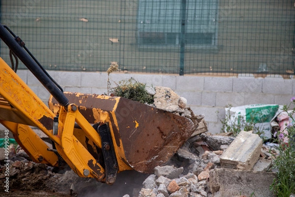 Obraz shovel picking up debris left over after completion of the construction site