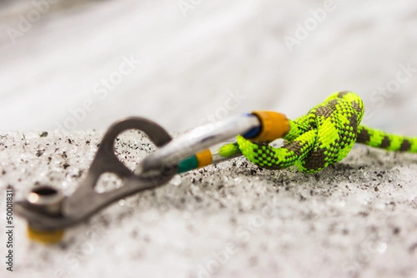 Fototapeta Carbine and hook with rope in ice