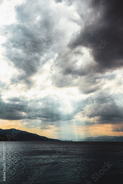 Obraz Clouds and rays on the sea