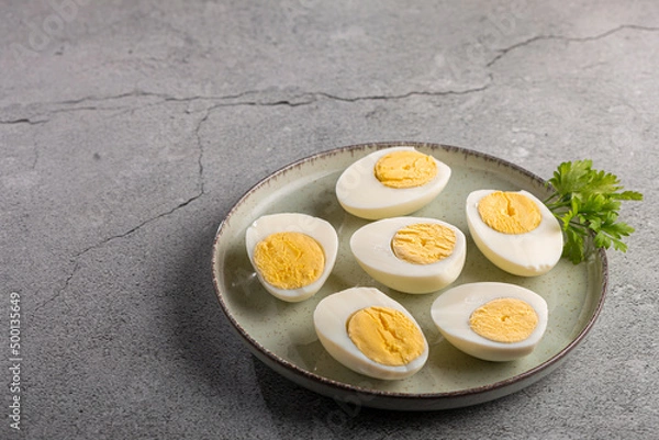 Fototapeta Sliced ​​boiled eggs on the table.