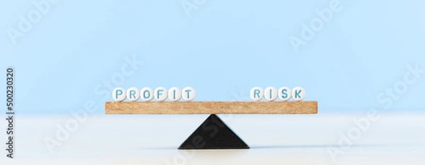 Fototapeta Risk and profit words on scale. Risk management concept and a risk reward ratio return of an investment.