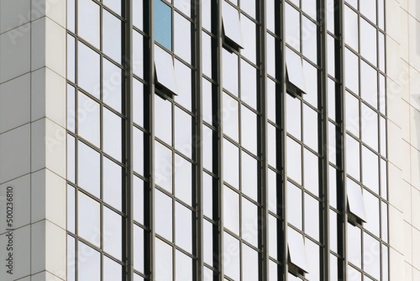 Obraz Geometric colored building facade elements with planes, lines and corners with light flare and reflections for an abstract background and texture of white, blue, gray colors. Place for text