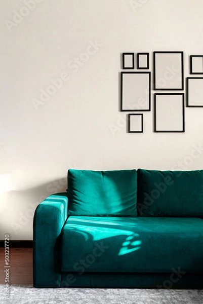 Obraz Part of interior with bright green sofa and empty photo frames.