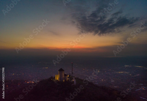 Fototapeta Fortress over the town of Vršac and the sunset. Aerial photography.