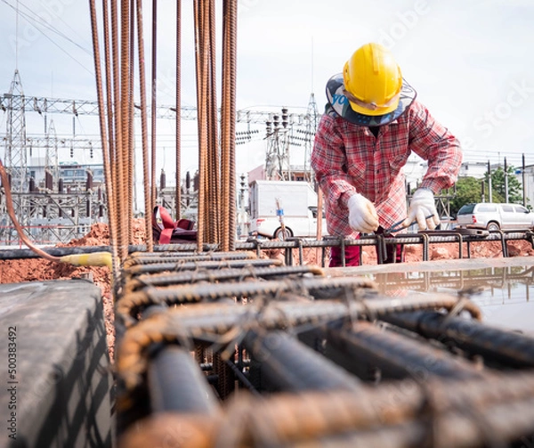 Obraz Construction workers fabricating steel reinforcement bar at the construction site. 