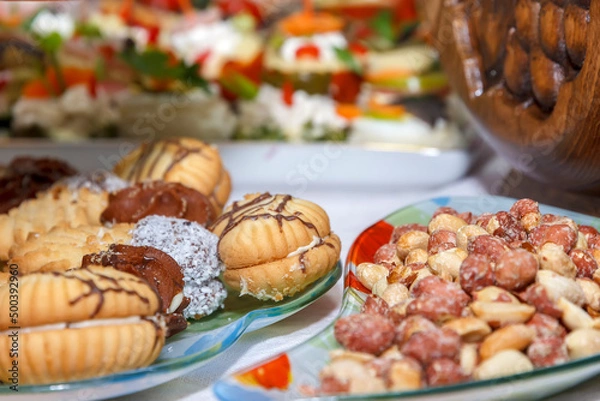 Fototapeta Set of different nuts and sweets on a table. Catering food party.
