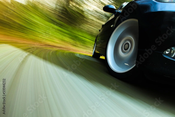 Obraz Side view of black car in turn.
