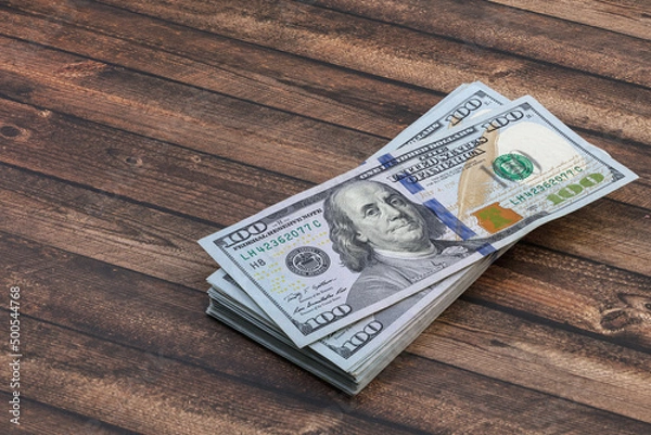 Fototapeta A large stack of hundred-dollar cash banknotes. Has a clipping path saved.