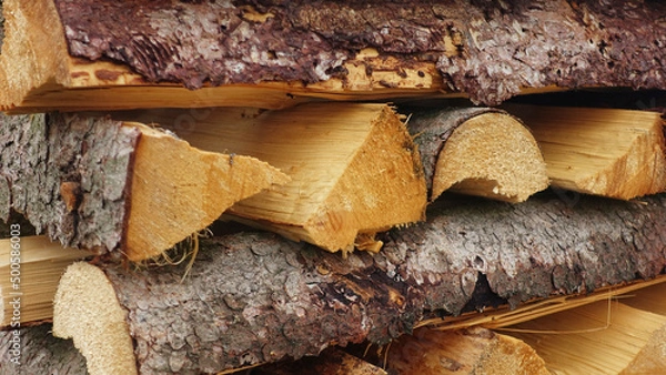 Fototapeta Firewood staggered stacked cut ready to dry structure 