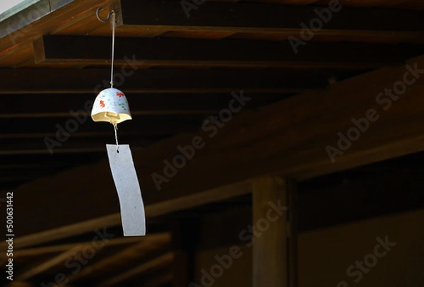 Obraz The eaves of a shop where a wind chime called "Furin", a Japanese summer tradition, is hung.