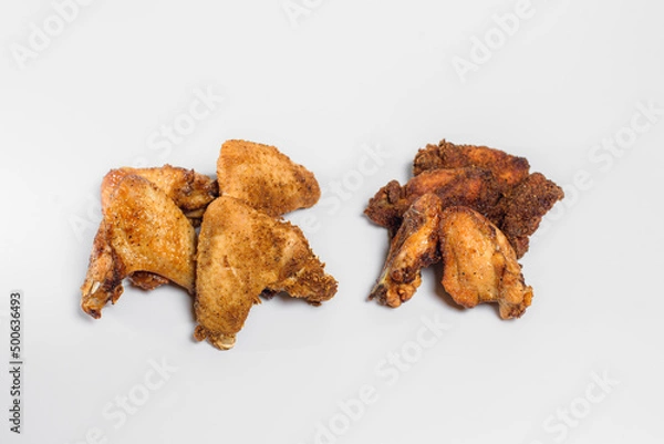 Fototapeta fried chicken wings in oil and breadcrumbs lie on a white background for three pieces