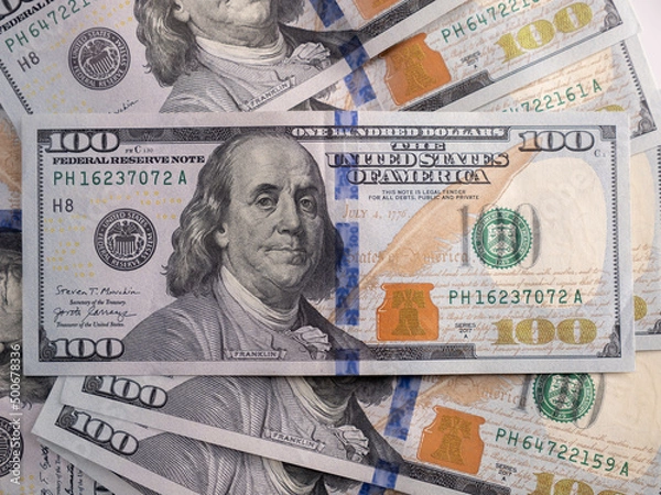 Fototapeta 100 US dollars bills lie on the table close-up