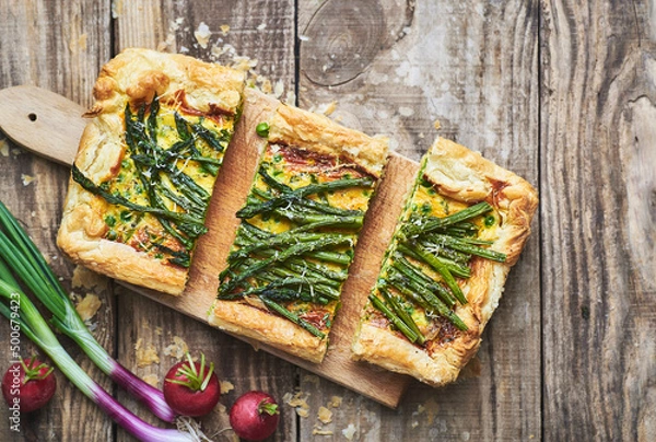 Obraz Vegetarian quiche pie with asparagus. Fresh homemade asparagus quiche pie served on rustic wooden table.