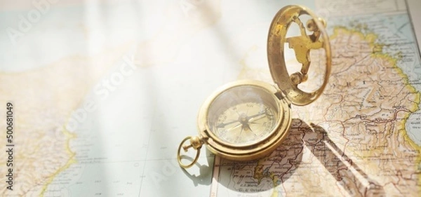 Obraz Retro style antique golden compass (sundial) and old nautical chart close-up. Vintage still life. Sailing accessories. Wanderlust, travel and navigation theme. Graphic resources, copy space