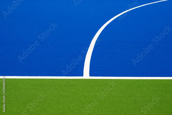 Fototapeta The corner of the artificial turf, the football field, the difference color on the ground , green, white, blue.