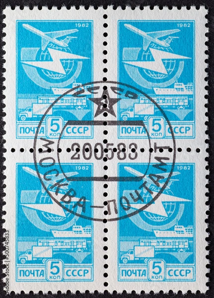 Fototapeta SOVIET UNION, USSR - CIRCA 1982: a postage stamp from SOVIET UNION, USSR , showing Postal Transport via plane, ship, railroad, truck and a globe with lightning.Circa 1982.