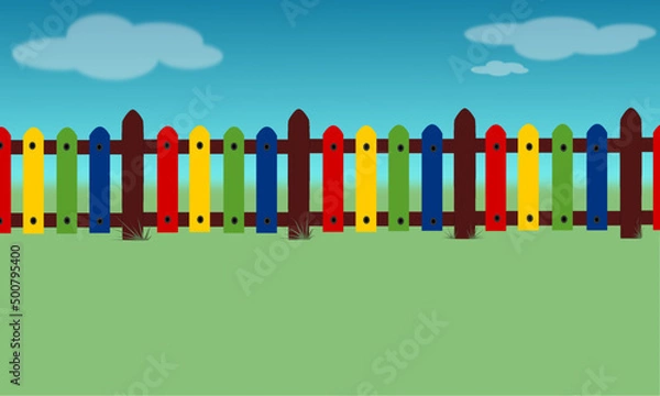 Fototapeta Colorful children's fence with blue sky and grass background