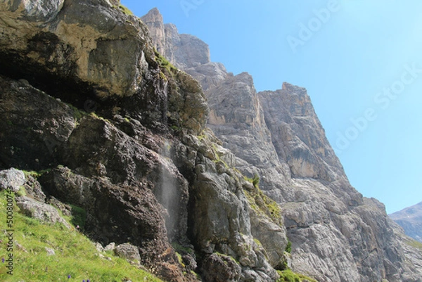 Fototapeta Mountain landscape in a sunny day. Waterfall stream in Italian Alps.