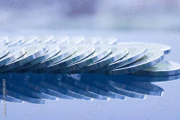 Fototapeta Close up of Thai Baht coins money arrange recline on table with mirror reflection in blue tone..