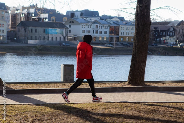 Fototapeta person walking on the street
