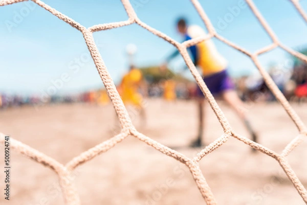 Fototapeta Unrecognizable goalkeeper throwing the ball during a soccer game on a beach in Masachapa, Nicaragua. Concept of popular sports in Latin America.