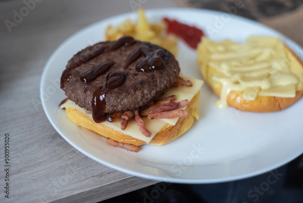 Fototapeta Handmade hamburger with french fries and dips made at home