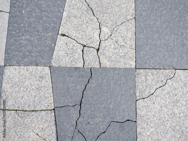 Fototapeta Cracks in pavement tiles. Masonry. The texture of the flooring.