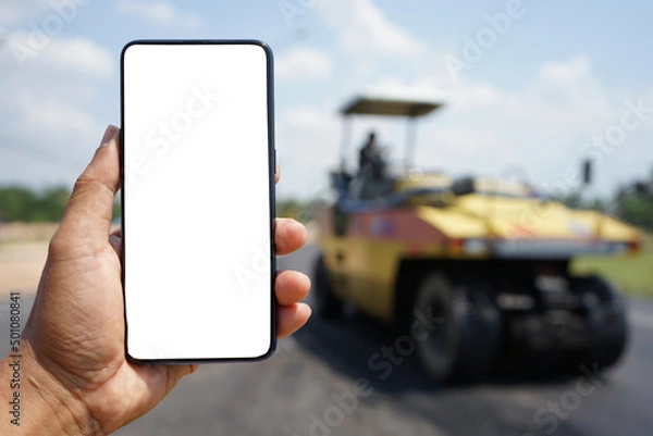 Obraz Mobile phone and road construction blur background