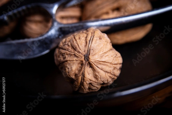 Obraz Nuts in a black plate