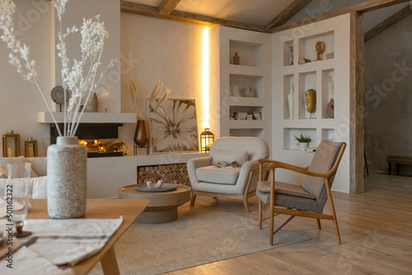 Obraz cozy warm home interior of a chic country house with an open plan, wood finishes, warm colors and a family hearth. view of the recreation area for family and guests