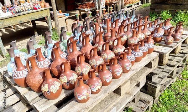 Obraz A counter with jugs and ceramic handicrafts made in  Georgian national style put up for sale
