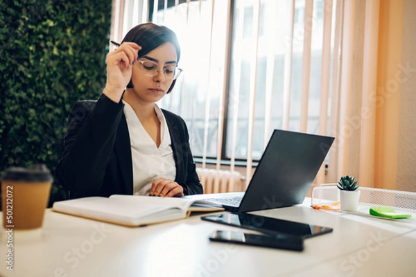 Fototapeta Business working on a laptop in a creative office environment