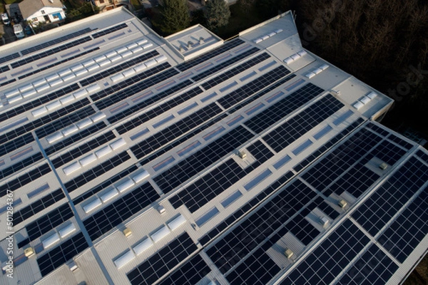 Obraz Industrial building with solar panels on the roof top for green energy production