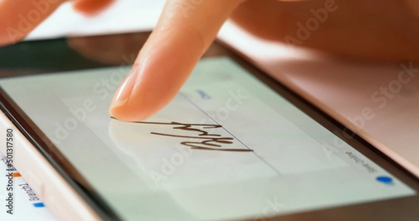 Fototapeta Sign document of deal on digital gadget. Digital signature on smartphone screen with woman hand. Close up.