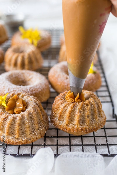Obraz Cinnamon doughnuts and cakes with dulce de leche