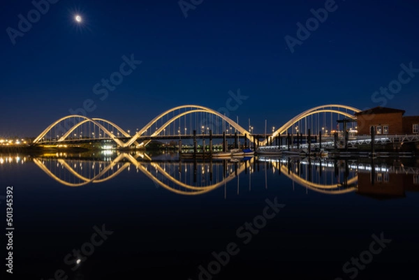 Fototapeta Waning Moon Over the Frederick Douglas Bridge and Anacostia River on a Spring Morning