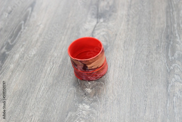Fototapeta slinky on the wooden floor. Top view, flat lay composition