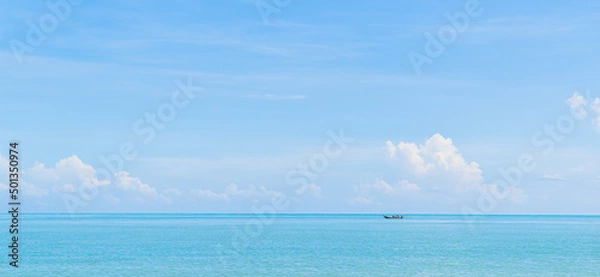Fototapeta Small traditional fishing boat minimal on blue sea and sky clouds in summer season 