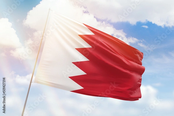 Obraz Sunny blue sky and a flagpole with the flag of bahrain